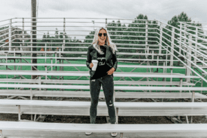 Carly Mal at bleachers with black leather jacket