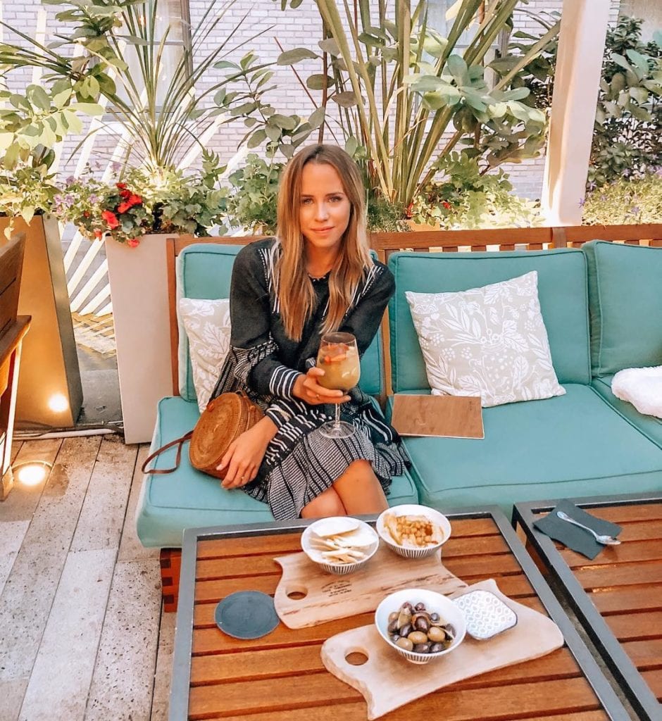 Jordan Sangster (@Jsangsterr) is a Kelowna-based blogger that loves to travel; here she is sitting on a beautiful patio wearing a trendy black dress